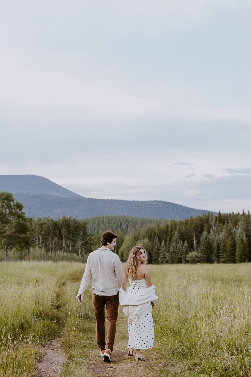 Mary Pratt and Nick walking through a field together